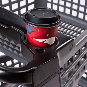 A cup of coffee sits in the cupholder of a Bemis cart.