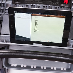 An iPad sits in the device holder of a Bemis cart.