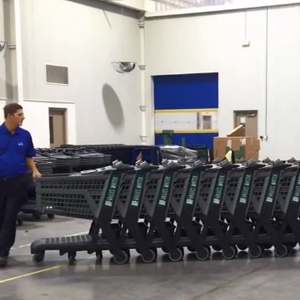 An employee moves a stack of carts easily.